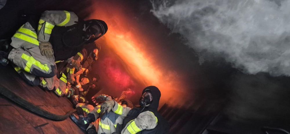 Feuerwehrleute im brennenden Container